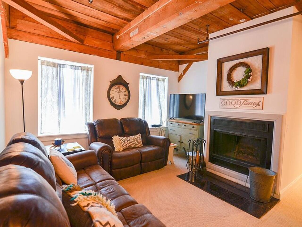 Mill Condo at Okemo living room with fireplace and timber beams